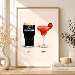 May include: A framed print featuring a pint of Guinness and a strawberry margarita. The Guinness glass is black with a white head, and the margarita is red with a strawberry garnish. The words "His" and "Hers" are below the drinks.