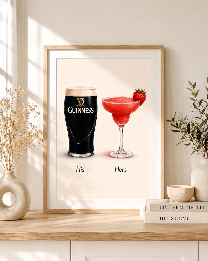 May include: A framed print featuring a pint of Guinness and a strawberry margarita. The Guinness glass is black with a white head, and the margarita is red with a strawberry garnish. The words "His" and "Hers" are below the drinks.