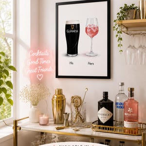 May include: A framed print featuring a pint of Guinness and a glass of pink cocktail, labeled "His" and "Hers." The image is part of a cocktail-themed wall art collection. The text "Cocktails Good Times Great Friends" is also visible.