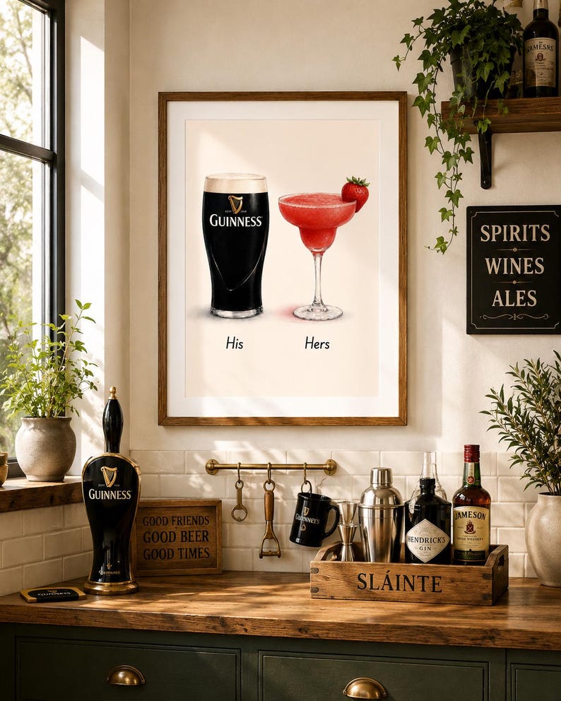 May include: A framed print featuring a pint of Guinness and a strawberry margarita, labeled "His" and "Hers." The image is set in a kitchen with bar accessories, including a Guinness tap, bottles, and a sign that reads "Spirits Wines Ales."