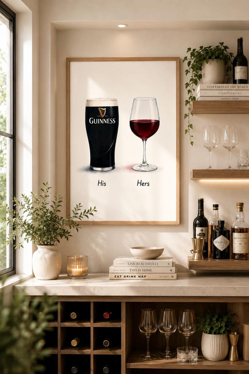 May include: A framed print featuring a pint of Guinness and a glass of red wine, labeled "His" and "Hers." The image is set in a home bar with wine bottles, glasses, and decorative items. The text "LIVE BEAUTIFULLY" is visible.