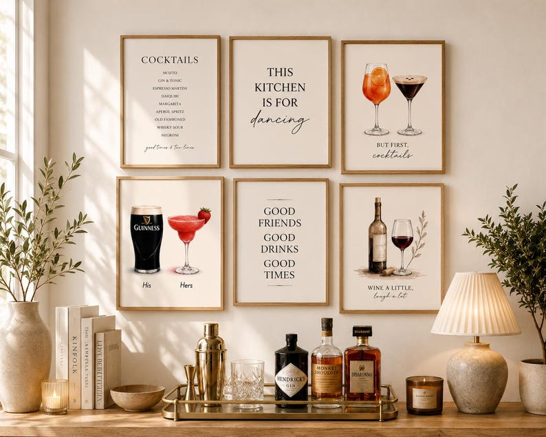 May include: A collection of framed art prints with a bar theme. The prints feature cocktail recipes, inspirational quotes, and illustrations of drinks like cocktails, wine, and beer. The color palette is neutral with a touch of gold.