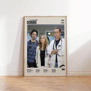 May include: A framed poster featuring the cast of the TV show "Scrubs." The poster shows three actors in medical attire, with the show's title at the top. The year "2001" is displayed in the bottom right corner.