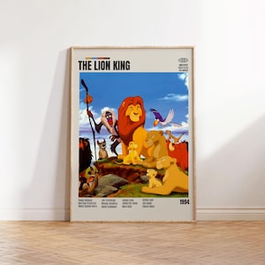 May include: A framed poster for "The Lion King" animated film. The poster shows a colourful scene with lion characters, a blue sky, and the text "THE LION KING" at the top, with the year 1994 at the bottom. The poster is displayed against a light-coloured wall.