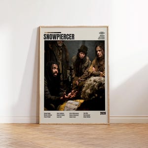 May include: A framed poster featuring the word "SNOWPIERCER" in bold black letters. The image shows a group of people in a dimly lit setting. The poster includes the year 2020 and the names of the cast and crew.