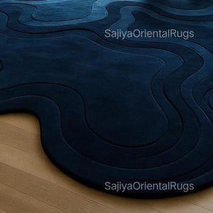 Detailed close-up of hand-tufted wool rug showing plush pile, rich deep blue color, and high-quality tufting craftsmanship.