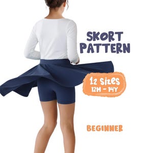 May include: A navy blue skort with a flared skirt overlay and fitted shorts underneath. Text on the image reads: SKORT PATTERN, 12 SIZES 12M - 14Y, and BEGINNER. The garment is shown from the back, featuring a solid color and simple construction.