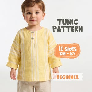 May include: A young child wearing a yellow tunic with vertical white stripes. The tunic has a buttoned neckline. Text on the image reads "TUNIC PATTERN", "11 Sizes 12M - 16Y", and "BEGINNER". The child is also wearing beige pants.