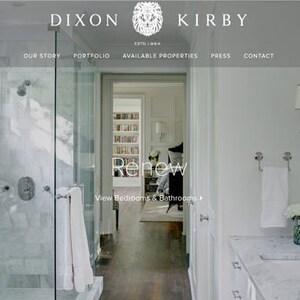 May include: A white bathroom with a large shower, a vanity with a marble countertop, and a mirror. The shower has a glass door and a white tile floor. The vanity has a white sink and a chrome faucet. The mirror is framed in white.