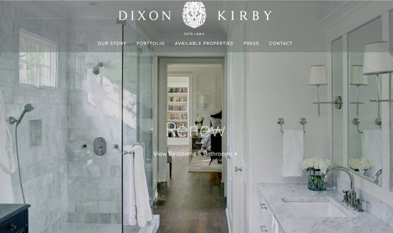 May include: A white bathroom with a large shower, a vanity with a marble countertop, and a mirror. The shower has a glass door and a white tile floor. The vanity has a white sink and a chrome faucet. The mirror is framed in white.
