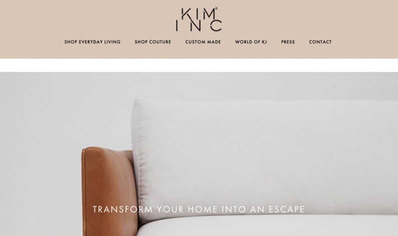 May include: A white leather sofa with a brown leather armrest. The sofa is in front of a white wall. The text "TRANSFORM YOUR HOME INTO AN ESCAPE" is displayed below the sofa.