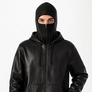 May include: Black hooded jacket with a full-face balaclava. The jacket features a front zipper, two front pockets, and ribbed cuffs and hem. The balaclava covers the entire head and neck, with an opening for the eyes.
