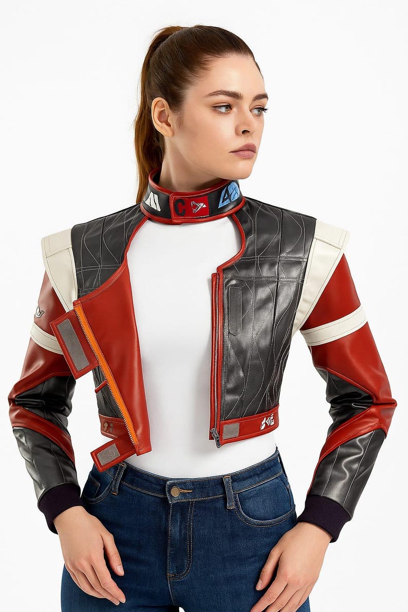 May include: A cropped, multi-colored leather jacket with a futuristic design. The jacket features a black quilted body, red sleeves, and white accents. The collar has colorful patches. The jacket is zipped up and has a unique, angular cut.