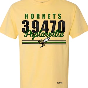 May include: A yellow t-shirt with the word "HORNETS" in green block letters above the numbers "39470" in black. Below the numbers is the word "Poplarville" in green script. A graphic of a bee is below the text.