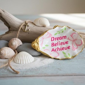 May include: A set of three ceramic mugs with a speckled, matte finish. The mugs are in shades of cream, light gray, and dark gray. Each mug has a simple, minimalist design, perfect for coffee or tea.