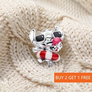 May include: A silver-toned charm featuring a character wearing black sunglasses and holding a pink ice cream cone. The character is positioned inside a red and white striped life preserver ring. The charm has a polished metallic finish.