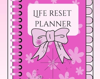 May include: A spiral-bound planner with a bright pink cover featuring a white rectangular label that reads LIFE RESET PLANNER. The cover is decorated with light pink flower shapes, sparkling star icons, and a large light pink bow in the center.