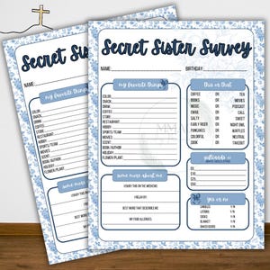 May include: Two Secret Sister Survey printable sheets with a blue floral border. The top of the sheets read "Secret Sister Survey" in a navy blue script. The sheets include fill-in-the-blank sections for favorite things and preferences.