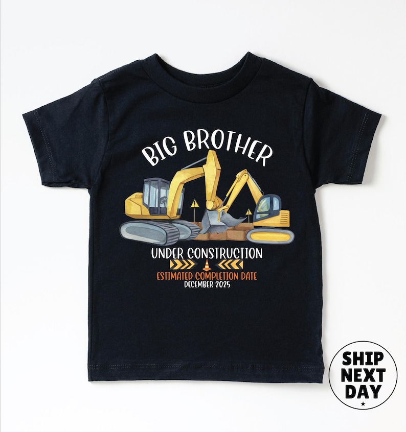 The image is a black t-shirt with a graphic design featuring a yellow excavator and the text "BIG BROTHER UNDER CONSTRUCTION ESTIMATED COMPLIMATION DATE DECEMBER 2023" printed on it.