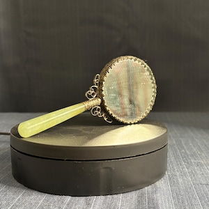 Japanese style mirror with painted bird on reverse and filigree handle brackets, 6 inches