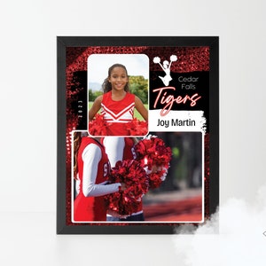 May include: A framed collage featuring a young cheerleader in a red and white uniform. The collage includes a photo of the cheerleader, a photo of the cheer squad, and a title card that reads "Cedar Falls Tigers" with the name "Joy Martin" below. The background is a red glitter pattern.