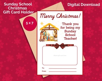 May include: A Christmas gift card holder with the text "Merry Christmas!" and "Thank you for being my Sunday School Teacher!" The card features a nativity scene illustration and a space to attach a gift card. The holder is 5x7 inches.