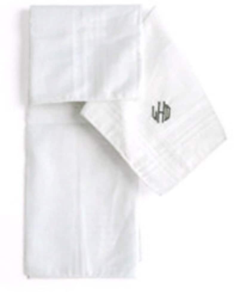May include: Two white linen handkerchiefs with a monogrammed initial "LHD" embroidered in gray on one handkerchief.