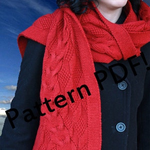 May include: A red knitted scarf with a cable knit pattern. The scarf is worn by a person wearing a black coat. The text "Pattern PDF!" is superimposed on the image.