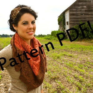 May include: A woman wearing a brown and orange patterned shawl with a feathered headband. The text "Pattern PDF!" is superimposed over the image.