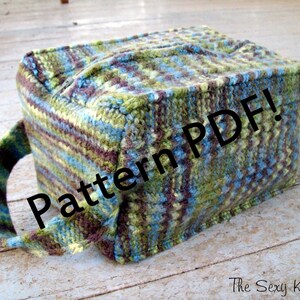 May include: A green, blue, and brown knitted tote bag with a zipper closure and a handle. The bag has the text "Pattern PDF!" printed on it.