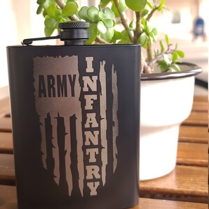 May include: Black metal flask with a silver inscription that reads "Army Infantry" and a stylized American flag design.