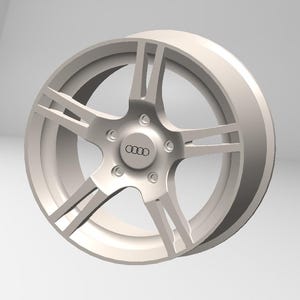Könnte beinhalten: Helle silberne Leichtmetallfelge mit Fünf-Speichen-Design. Das Rad hat eine zentrale Nabe mit dem Audi-Logo und ist vor einem neutralen Hintergrund platziert. Die Felge hat eine glatte, saubere Oberfläche und zeigt eine moderne Autoästhetik.