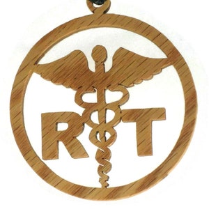 May include: A wooden pendant with a medical symbol and the letters "RT" carved into it. The pendant is on a black cord.
