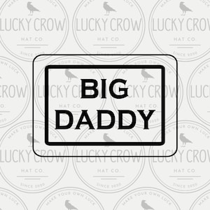 May include: A digital mock-up featuring a design for a hat. The design includes the text "BIG DADDY" in a black, bold font, framed within a black rectangle. The background is a pattern of circular logos with a crow and the text "LUCKY CROW HAT CO."