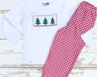 May include: White long-sleeved pajama top with an embroidered Christmas tree design and red gingham pajama pants. The top features three green Christmas trees with yellow star accents within a rectangular frame.