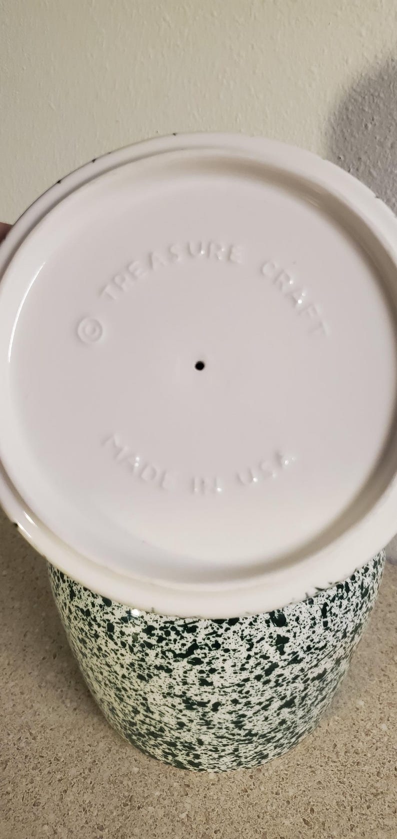 May include: A set of three ceramic mugs with a speckled, matte finish. The mugs are in shades of cream, light brown, and dark brown. Each mug has a simple, minimalist design and a rounded handle.
