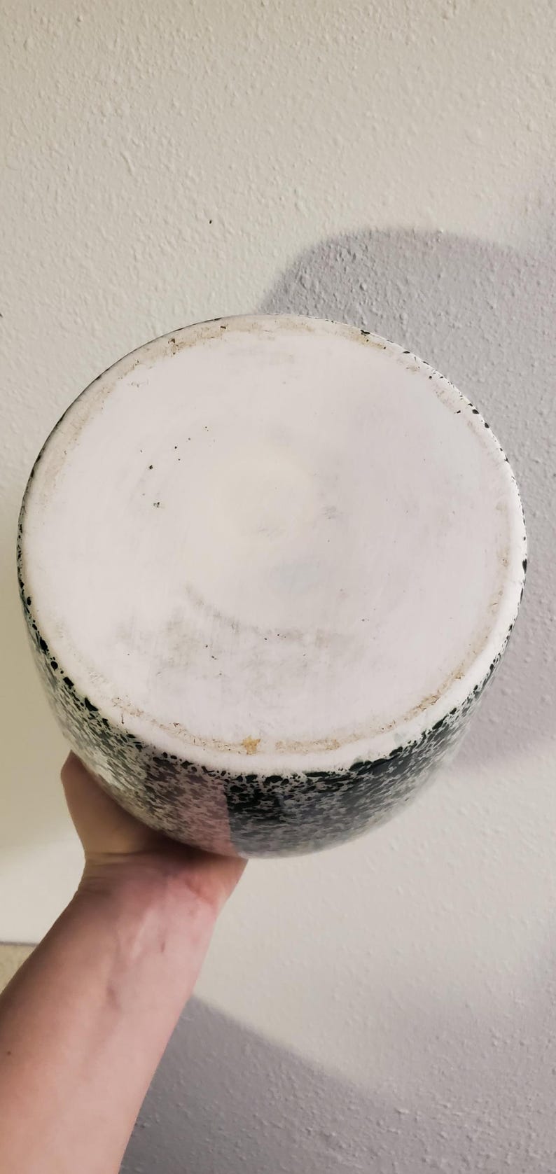 May include: A set of three ceramic mugs with a speckled, matte finish. The mugs are in shades of cream, light gray, and dark gray. Each mug has a simple, minimalist design and a rounded handle.