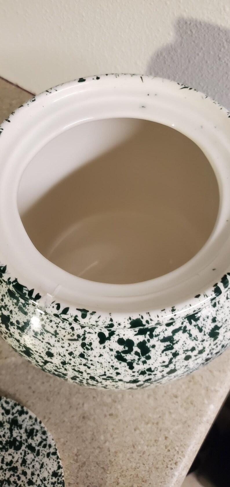 May include: A white ceramic mug with a black handle and the text "But First, Coffee" in a bold, black font. The mug is sitting on a wooden surface. The mug is approximately 4 inches tall.