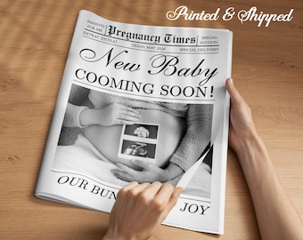 May include: A black and white newspaper titled "Pregnancy Times" with the headline "New Baby COOMING SOON!" The newspaper features an image of a pregnant belly with sonogram photos. The text "OUR BUN JOY" is visible.