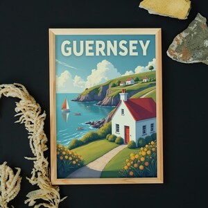 May include: Wooden framed print featuring a coastal scene with the word "GUERNSEY" at the top. The artwork depicts a white cottage with a red roof, a sailboat, and a winding path along a green hillside. Yellow flowers line the path.