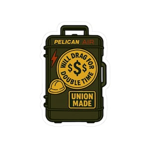 May include: A sticker featuring a green Pelican Air suitcase design. The sticker includes a yellow circle with the text "WILL DRAG FOR DOUBLE TIME" around dollar signs. A hard hat and lightning bolt are also included, along with the words "UNION MADE".