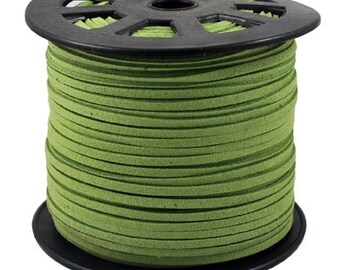 May include: A spool of green suede cord, wound tightly on a black plastic spool. The cord is smooth and has a subtle texture.