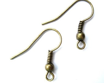 May include: Two antique gold earring hooks with a spring and a ball at the end.