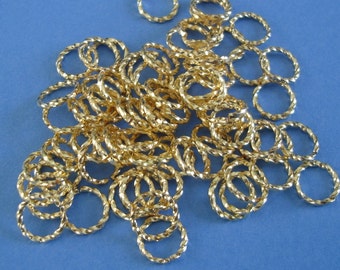 100 anillos de salto, chapados en oro brillante, trenzados, 9 mm, calibre 17.