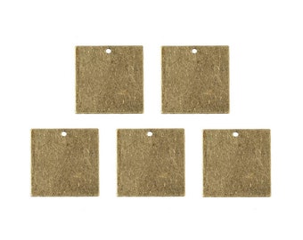 May include: Six antique gold-toned metal square tags with a hole at the top. The tags are blank and ready for personalization.