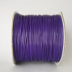 May include: A spool of purple waxed cord, perfect for crafting and jewelry making.