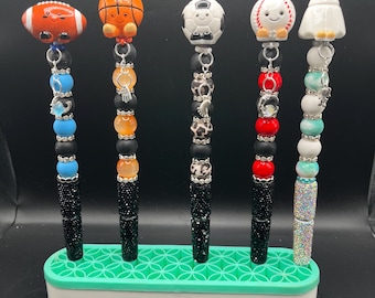 Bolígrafos con motivos deportivos y cuentas