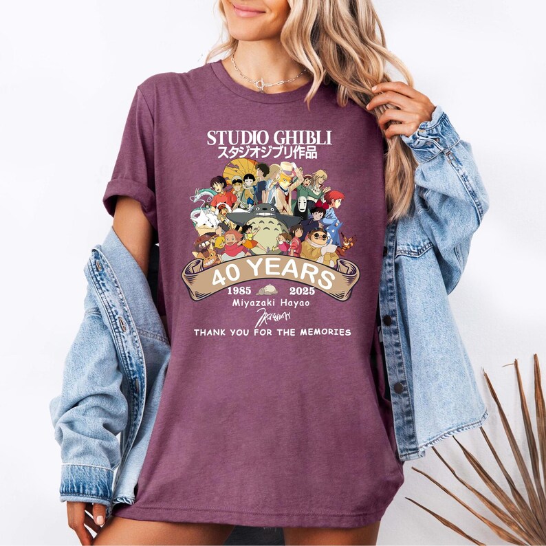 May include: A maroon t-shirt featuring a colorful graphic of Studio Ghibli characters celebrating 40 years. The design includes the text "STUDIO GHIBLI" in English and Japanese, along with "40 YEARS" and "THANK YOU FOR THE MEMORIES."