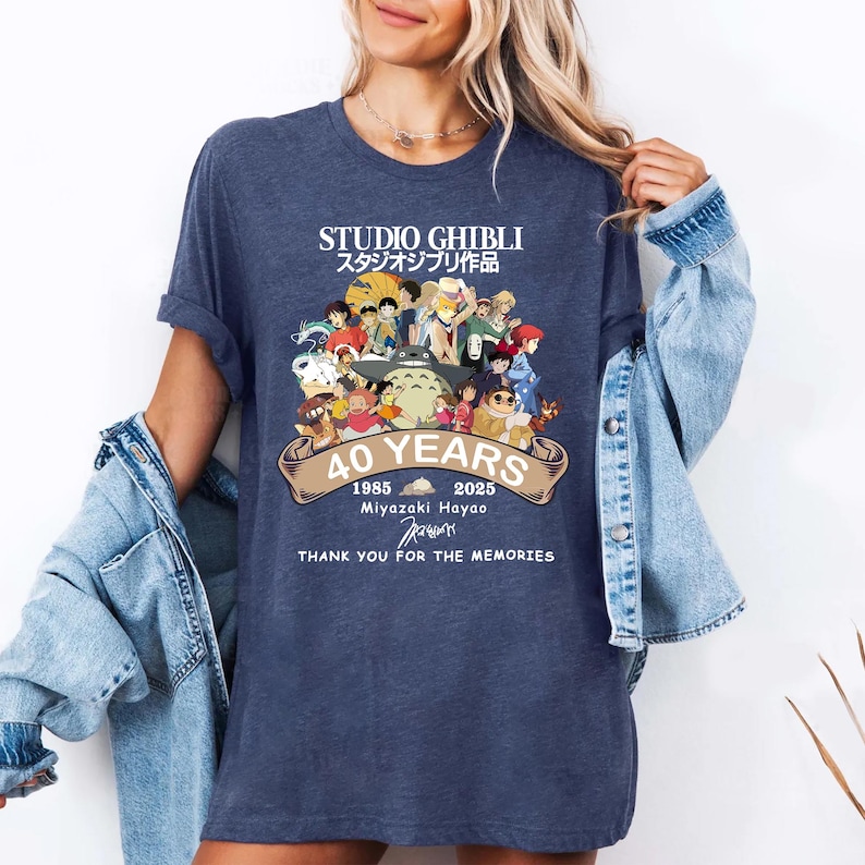 May include: Navy blue t-shirt featuring a graphic celebrating Studio Ghibli's 40th anniversary. The design includes characters from various Ghibli films, the text "STUDIO GHIBLI" in English and Japanese, and the years 1985-2025.