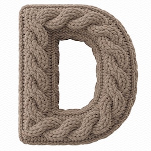 May include: A knitted letter "D" in a light brown color. The letter is made with a thick cable knit pattern, giving it a textured appearance. The background is a white zigzag pattern.